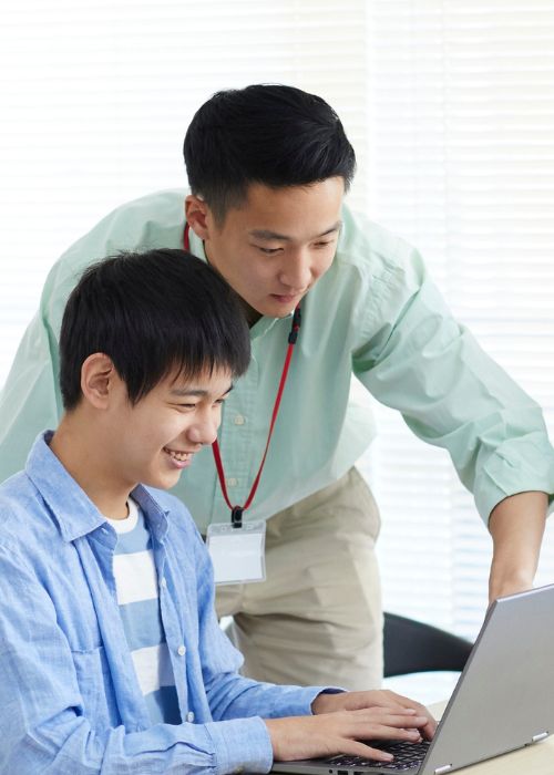 Two colleagues working together at a laptop