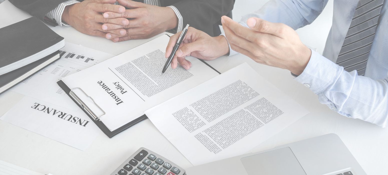 Hands reviewing an insurance document at a desk